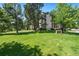 Low rise brick apartment building with mature shade trees and green lawn at 7040 E Girard Ave # 207, Denver, CO 80224