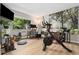 Home gym with Peloton bike, desk and nature-inspired mural at 7040 E Girard Ave # 207, Denver, CO 80224