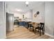 Updated kitchen with stainless steel appliances, bright white subway tile, and seating at a wooden table at 7040 E Girard Ave # 207, Denver, CO 80224