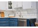 Updated kitchen features stainless steel appliances, white countertops, blue cabinets, and bright subway tile backsplash at 7040 E Girard Ave # 207, Denver, CO 80224