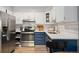 Beautifully updated kitchen features stainless steel appliances, white countertops, and bright subway tile backsplash at 7040 E Girard Ave # 207, Denver, CO 80224