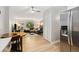 Open concept living and dining room with wood-look floors, great natural light and modern appliances at 7040 E Girard Ave # 207, Denver, CO 80224