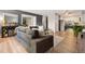 Open-concept living room and kitchen area with wood flooring and modern furnishings at 7040 E Girard Ave # 207, Denver, CO 80224