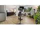Open concept living area staged with exercise equipment, desk, and modern furniture at 7040 E Girard Ave # 207, Denver, CO 80224