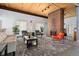 Inviting living room area featuring modern furniture, a fireplace, and a unique wood-paneled ceiling at 7040 E Girard Ave # 207, Denver, CO 80224