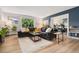 Comfortable living room featuring a plush sofa, stylish coffee tables, and a sliding glass door with outdoor views at 7040 E Girard Ave # 207, Denver, CO 80224