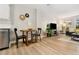Open floorplan, dining and living room with wood-look flooring and natural light at 7040 E Girard Ave # 207, Denver, CO 80224