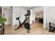 Bright living room staged as an exercise room, including doors to another room and storage at 7040 E Girard Ave # 207, Denver, CO 80224