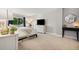 Bright main bedroom featuring a large window with tree views, a dresser, and soft decor at 7040 E Girard Ave # 207, Denver, CO 80224