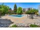 Community outdoor pool with seating, grill, and building in the background at 7040 E Girard Ave # 207, Denver, CO 80224