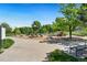 Community playground surrounded by natural elements and mature trees at 7040 E Girard Ave # 207, Denver, CO 80224
