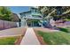 Backyard featuring an elevated deck, walkout basement, mature tree, and green lawn at 3883 S Fraser St, Aurora, CO 80014