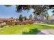 Fenced backyard with lush green grass, mature trees, and well-maintained landscaping at 3883 S Fraser St, Aurora, CO 80014