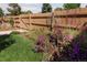 Charming backyard garden with vibrant flowers and a decorative tree-of-life wall accent at 3883 S Fraser St, Aurora, CO 80014