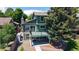 Backyard view featuring a spacious deck, mature trees, and a well-maintained green lawn at 3883 S Fraser St, Aurora, CO 80014
