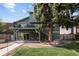 Green backyard includes a deck, patio, landscaped area, and lush lawn at 3883 S Fraser St, Aurora, CO 80014