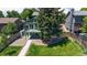 Green lawn, mature tree, elevated deck, and fencing highlight the backyard at 3883 S Fraser St, Aurora, CO 80014