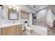 Modern bathroom features stylish vanity, tiled shower with handrails, and contemporary finishes at 3883 S Fraser St, Aurora, CO 80014