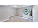 Cozy bedroom features plush carpet, a large window with natural light, and neutral color scheme at 3883 S Fraser St, Aurora, CO 80014