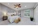 Beautiful primary bedroom with luxurious bedding, ceiling fan, and ample natural light at 3883 S Fraser St, Aurora, CO 80014