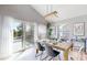 Bright dining area with vaulted ceilings and sliding glass doors to outdoor deck at 3883 S Fraser St, Aurora, CO 80014