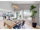 Bright dining area with vaulted ceilings and sliding glass doors to outdoor deck at 3883 S Fraser St, Aurora, CO 80014