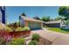 Inviting home exterior featuring a well-manicured lawn, brick accents, and a charming green garage door at 3883 S Fraser St, Aurora, CO 80014