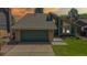 Charming two-story home featuring an attached two-car garage and landscaped front yard at 3883 S Fraser St, Aurora, CO 80014