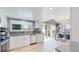 Modern kitchen with stainless steel appliances, granite countertops, and dining area at 3883 S Fraser St, Aurora, CO 80014