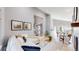 Bright living room with modern decor and open floor plan leading to dining area at 3883 S Fraser St, Aurora, CO 80014