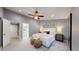 Elegant main bedroom with plush carpet, ceiling fan, and attached bathroom at 3883 S Fraser St, Aurora, CO 80014