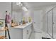 Bathroom featuring a double sink vanity with marble floors at 8145 Monte Vista Cir, Littleton, CO 80125