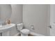 Cozy bathroom with pedestal sink and white toilet offers a clean, simple design at 8145 Monte Vista Cir, Littleton, CO 80125