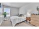 Bright bedroom featuring a large window, neutral carpet, and modern furnishings at 8145 Monte Vista Cir, Littleton, CO 80125