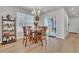 Bright dining room with a chandelier, wood table, and sliding door access to the outdoor area at 8145 Monte Vista Cir, Littleton, CO 80125