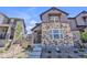 Contemporary townhouse featuring a stone facade and meticulously landscaped front yard at 8145 Monte Vista Cir, Littleton, CO 80125