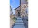 Inviting townhouse entrance featuring stone accents and well-maintained landscaping at 8145 Monte Vista Cir, Littleton, CO 80125
