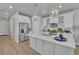 Well-lit kitchen with an island and quartz countertop, stainless steel appliances, and wood flooring at 8145 Monte Vista Cir, Littleton, CO 80125