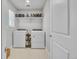 Well-lit laundry room featuring a washer and dryer, built-in shelving and tile flooring at 8145 Monte Vista Cir, Littleton, CO 80125
