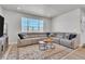 Comfortable living room with a large sectional sofa, area rug, and bright natural light at 8145 Monte Vista Cir, Littleton, CO 80125