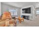 Comfortable living area features TV, a large window, and inviting decor at 8145 Monte Vista Cir, Littleton, CO 80125