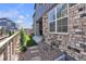 Side yard with stone accents, wooden fence, and artificial grass at 8145 Monte Vista Cir, Littleton, CO 80125