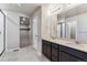 Elegant bathroom with double sink vanity, walk-in shower, and a large walk-in closet at 4284 Gozzer Ranch Dr, Elizabeth, CO 80107