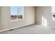Bright bedroom with a large window offering neighborhood views and neutral tones, creating a serene space at 4284 Gozzer Ranch Dr, Elizabeth, CO 80107