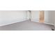Neutral bedroom showcases a new carpet, paint, and a doorway leading to bathroom at 4284 Gozzer Ranch Dr, Elizabeth, CO 80107