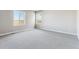 Bright, spacious bedroom with neutral carpet, base trim and large windows offering natural light at 4284 Gozzer Ranch Dr, Elizabeth, CO 80107