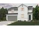 Charming two-story home with a gray two-car garage and landscaped front yard at 4284 Gozzer Ranch Dr, Elizabeth, CO 80107