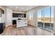 Modern kitchen boasts stainless appliances, island with breakfast bar, and sliding glass doors to the backyard at 4284 Gozzer Ranch Dr, Elizabeth, CO 80107