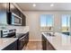 Chic kitchen featuring stainless appliances, stylish cabinets, and a bright window for natural light at 4284 Gozzer Ranch Dr, Elizabeth, CO 80107
