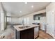 Kitchen with stainless appliances, island with sink and dishwasher, and open layout to living area at 4284 Gozzer Ranch Dr, Elizabeth, CO 80107